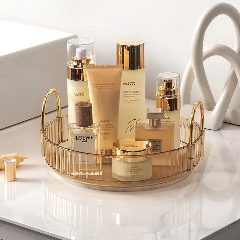 Three-layer rotating bathroom cosmetics storage rack in green on a desktop, with bottles on each tier.