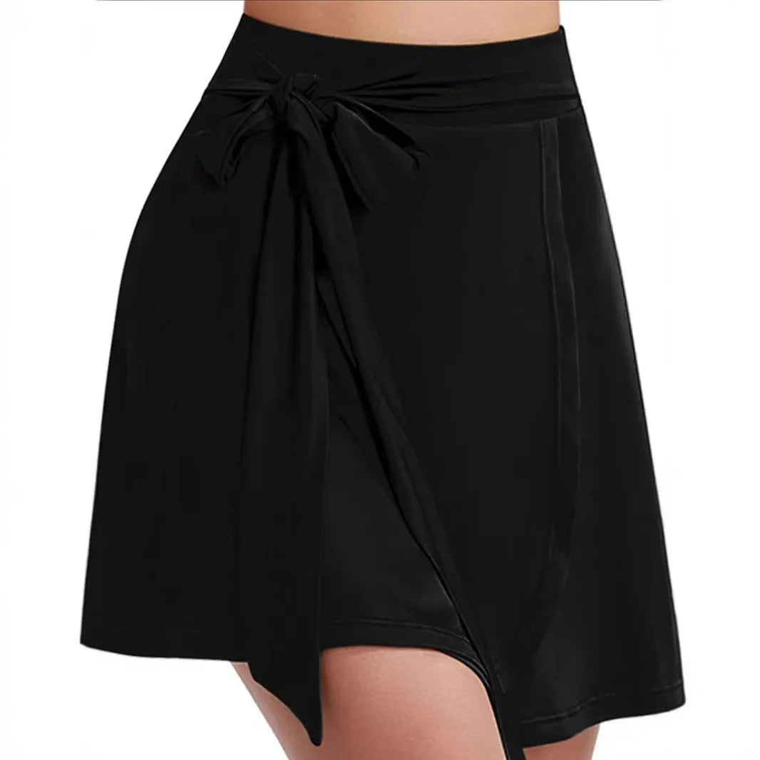 Black thigh-length sports skirt with built-in shorts and adjustable shoulder strap