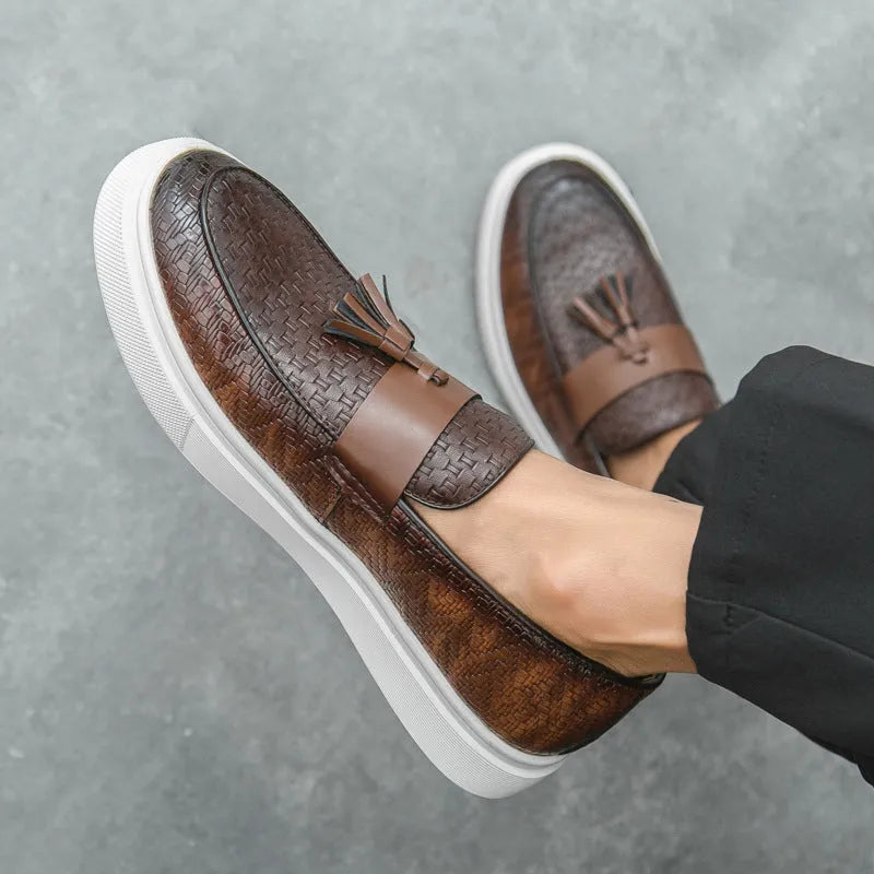 Men's black casual leather shoes with fringe detail on round toe, low heel.