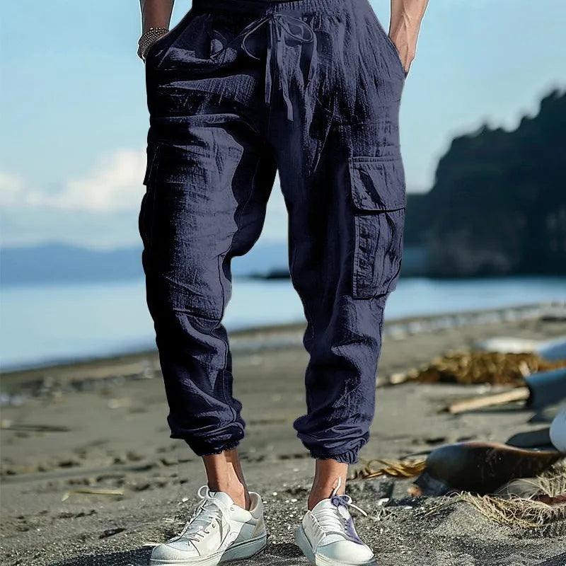Men's solid colour linen casual trousers with ankle ties and multiple pockets in a loose fit.
