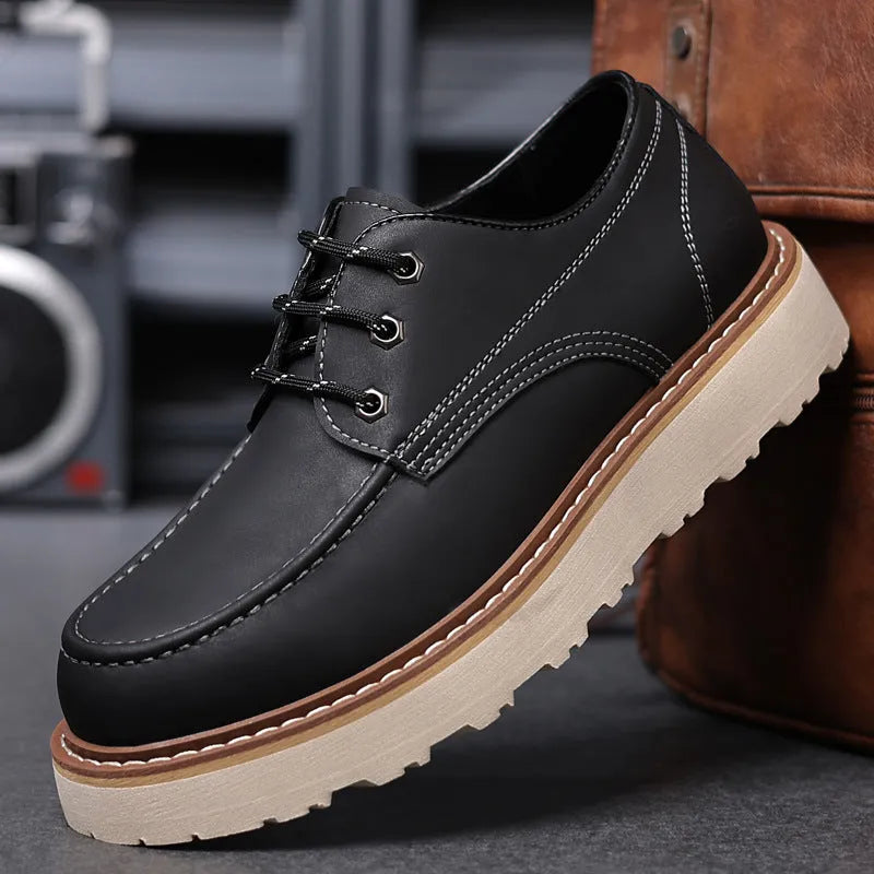 A pair of men's black retro-style low-top casual boots with a round toe and a rubber sole.