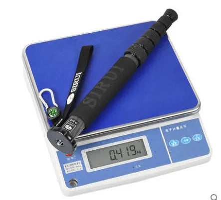 Black carbon fibre six-section SLR camera monopod extended to full height.