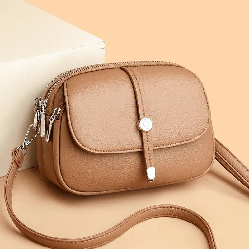 Soft PU oval-shaped women's crossbody shoulder bag in dark brown with sewing thread details.