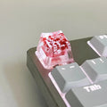 Transparent resin keycap with glitter particles creating starry night effect for mechanical keyboards