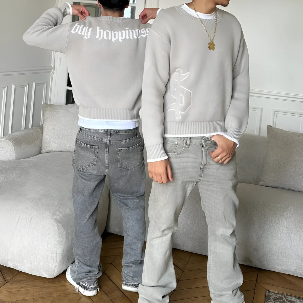 Gray loose-fitting Jacquard knitwear coat with long sleeves on a hanger.