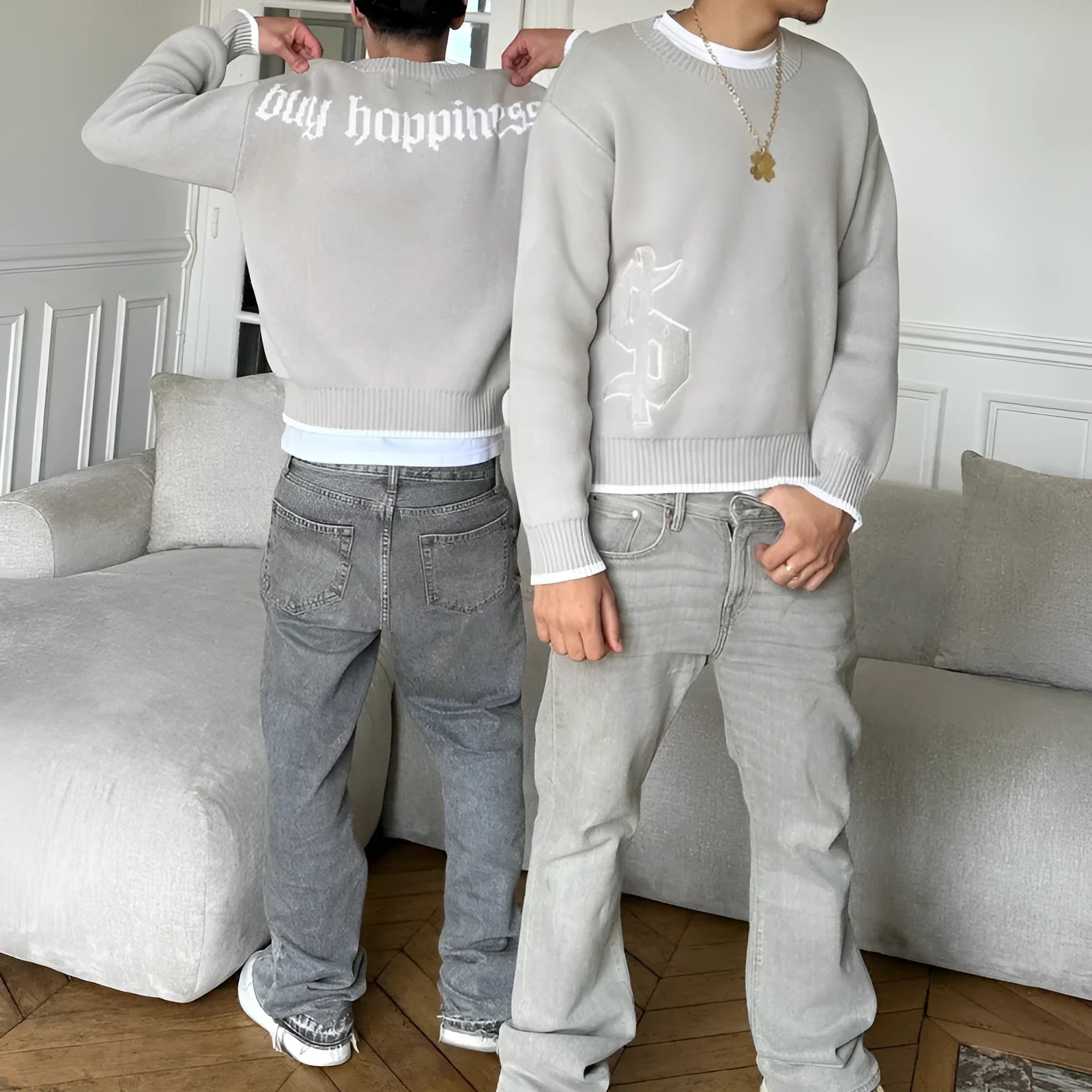 Gray loose-fitting Jacquard knitwear coat with long sleeves on a hanger.