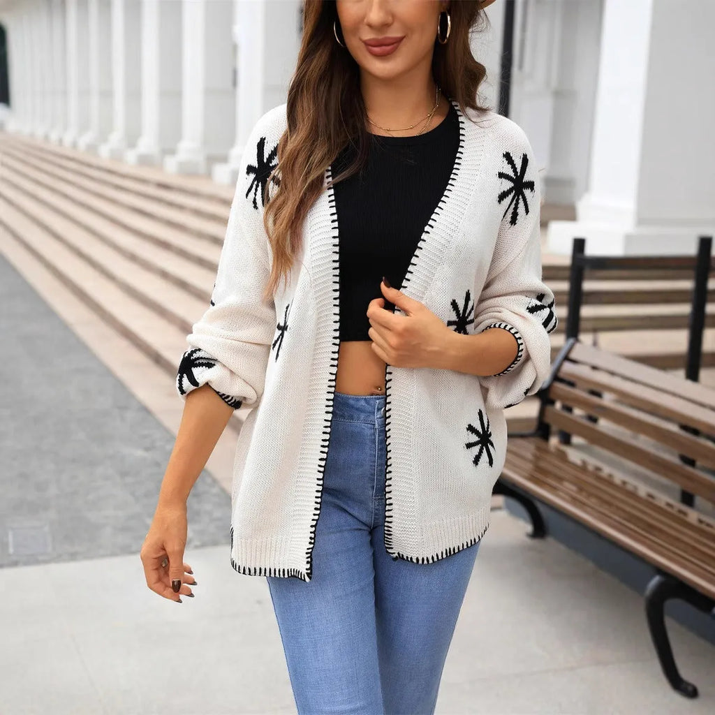 Plus size women's jacquard knitted coat with floral pattern in beige or orange colours, showing off-neck design and loose fit