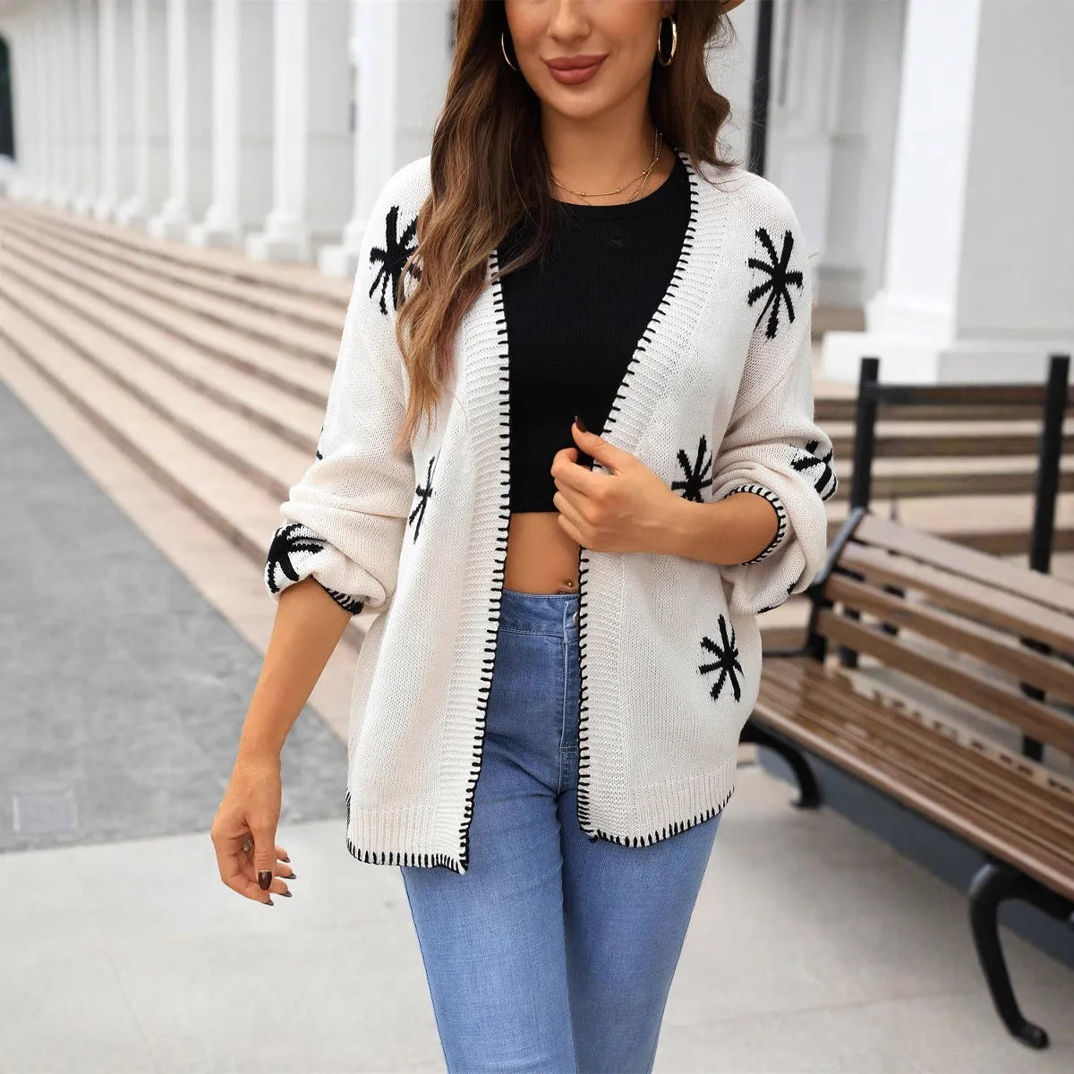 Plus size women's jacquard knitted coat with floral pattern in beige or orange colours, showing off-neck design and loose fit