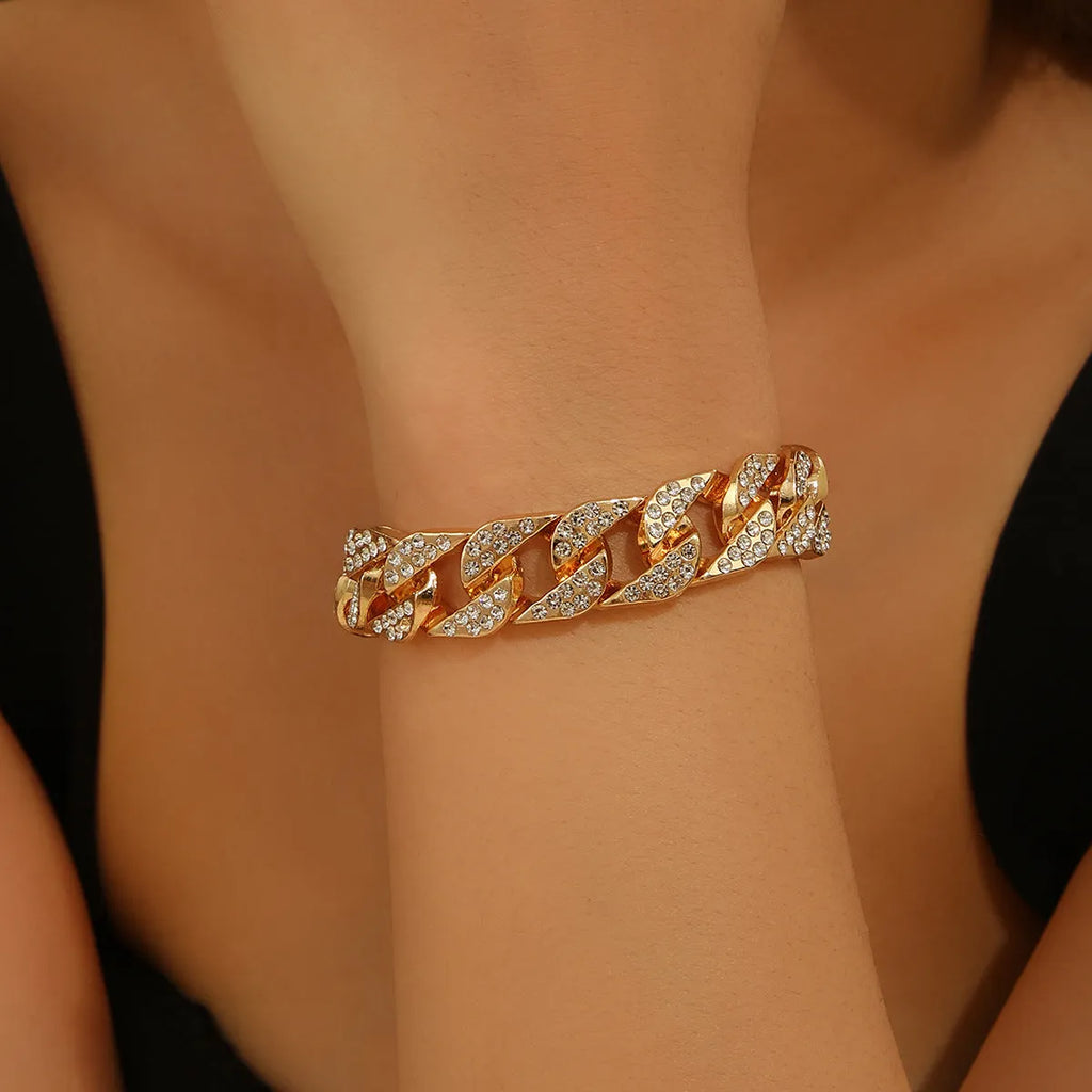 Full diamond heavy metal rap bracelet in gold with chunky link construction and diamond cut surface.