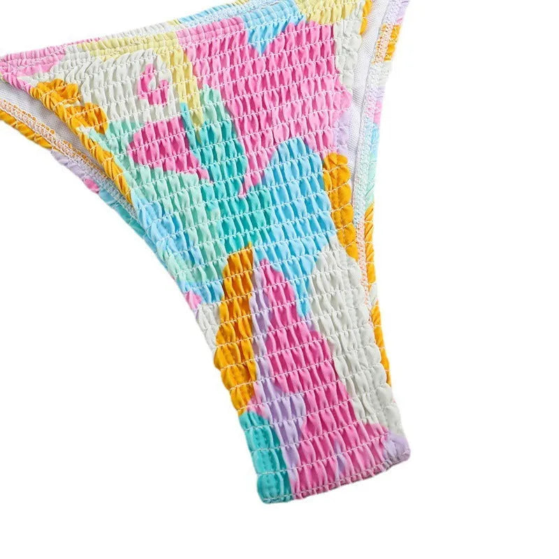 Women's multicolour floral triangle bag bikini swimsuit with split printed design and smocking craft detail.