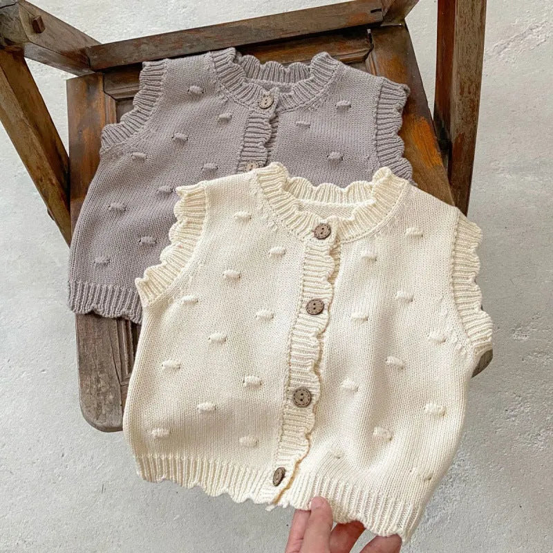 Children's knitted polka dot vest in apricot with single-breasted closure, featuring a sleeveless design for spring and autumn