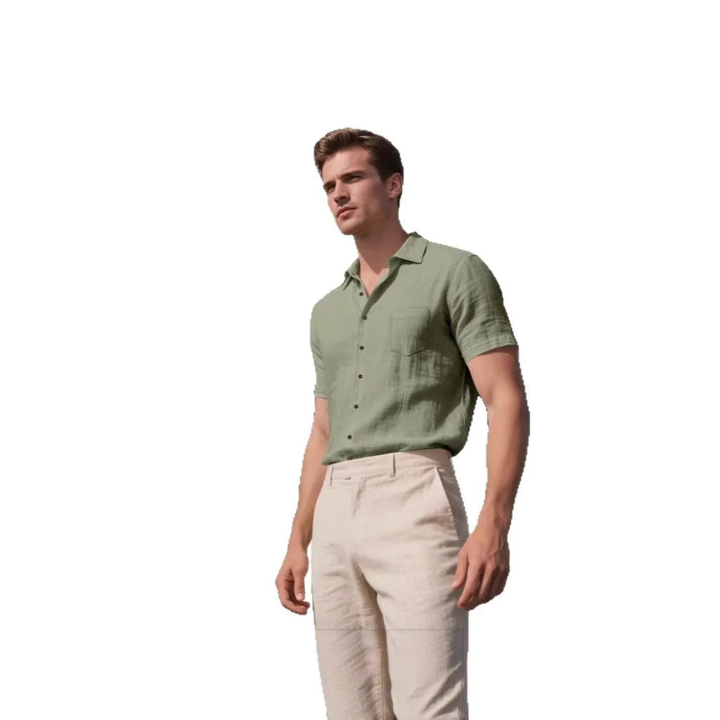 Man wearing a loose-fit light blue linen short-sleeved shirt in a casual setting.