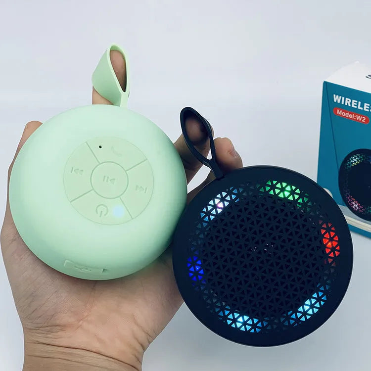 Pink mini Bluetooth speaker with plastic shell and button controls, 82x82x40mm