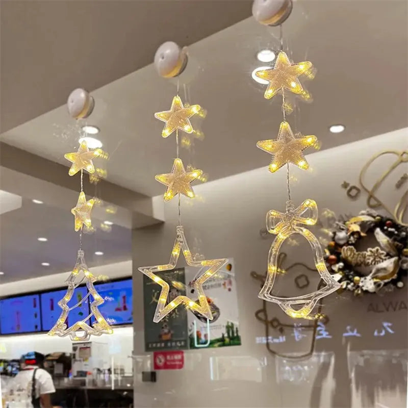 Three Christmas LED light ornaments with suction cups hanging on window