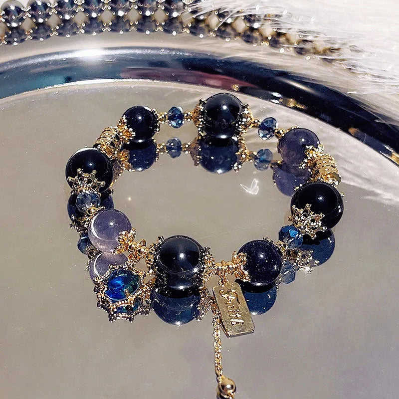 Women's galaxy-coloured alloy bracelet with a snowflake pendant and sweet bow design.