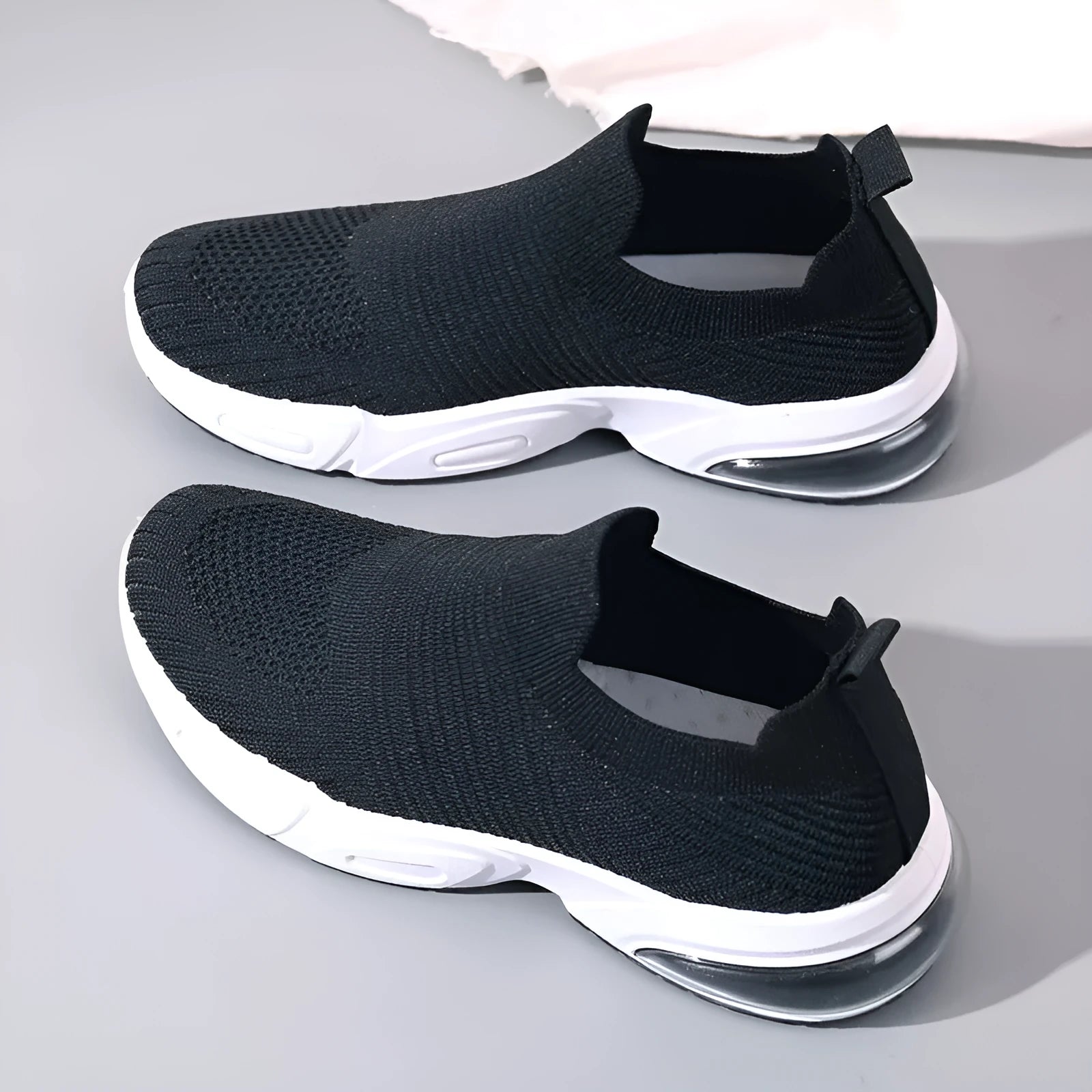Slip-on breathable sock shoes in black, pink, khaki, and white colours on a white background.