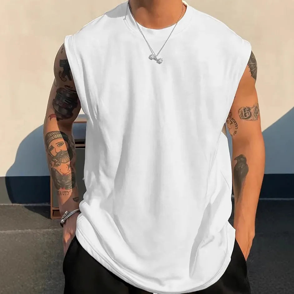 Man wearing a loose-fit solid colour cotton sleeveless tank top for summer.
