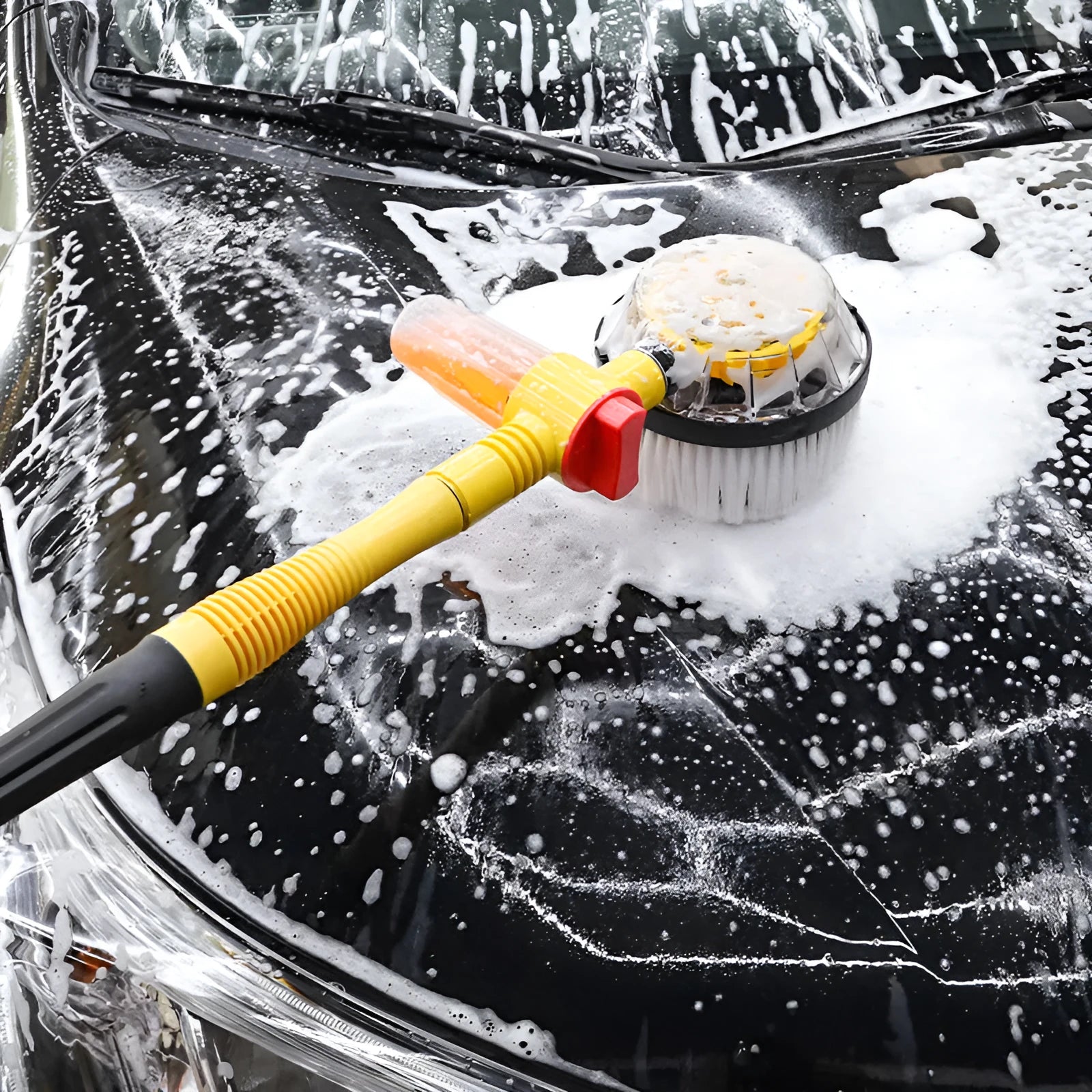 Bright yellow car wash mop cleaning tool with a long hose and a brush head featuring chenille and outer plastic bristles.