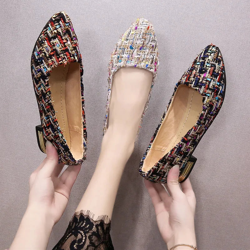 Women's black and white canvas flats with pointed toe and lace-up design