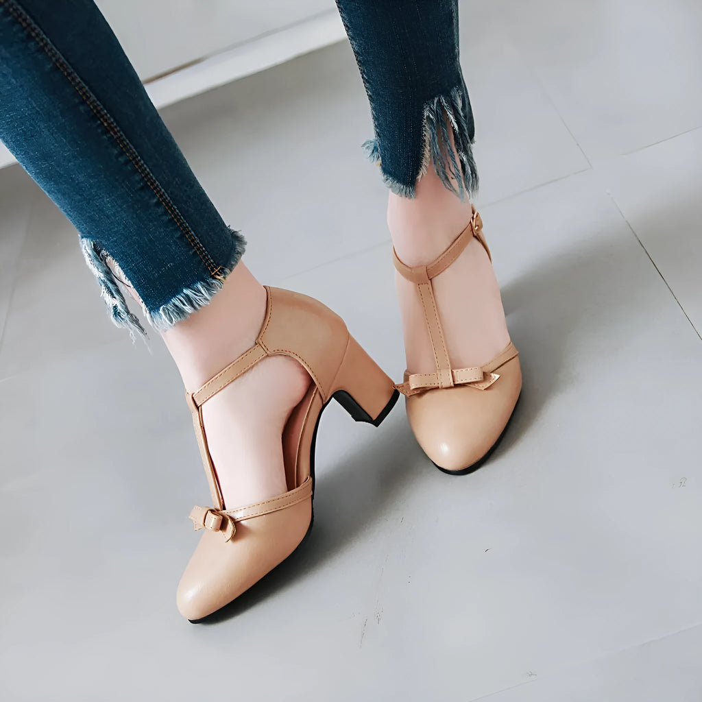 Yellow women's chunky heel sandals with a buckle strap and bow detail on a solid colour PU upper.