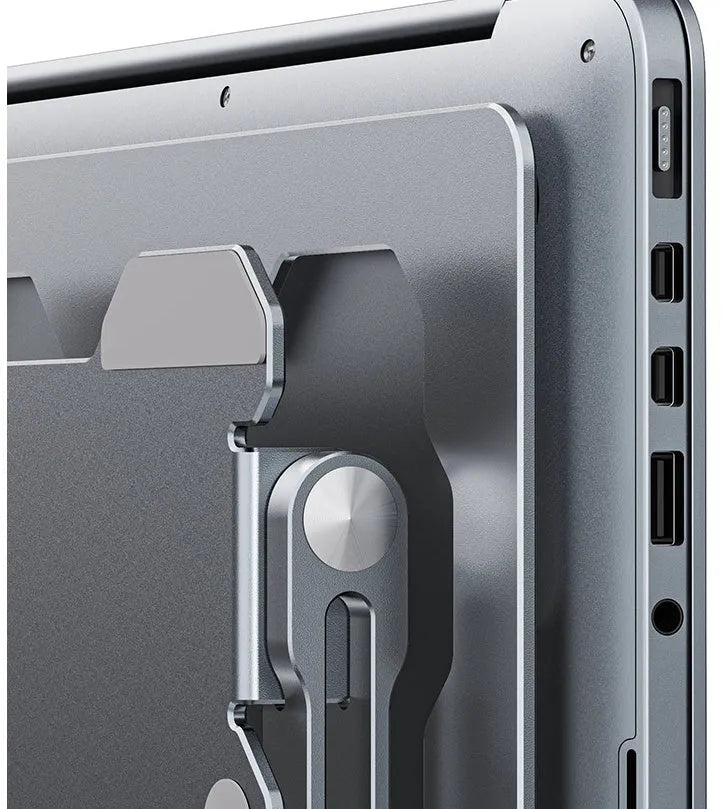 Grey aluminium laptop stand with adjustable angle, shown holding a silver laptop.