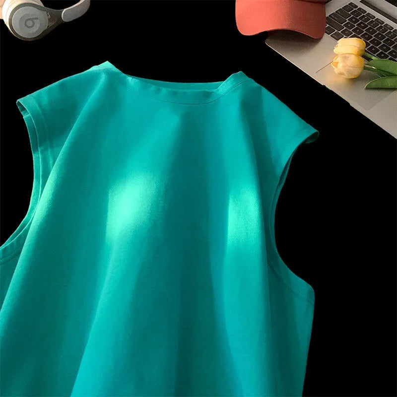 Man wearing a loose-fit solid colour cotton sleeveless tank top for summer.