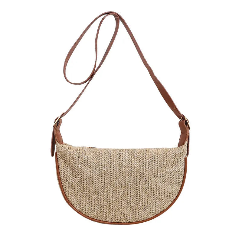 Straw woven crossbody bag showing woven texture and internal phone compartment