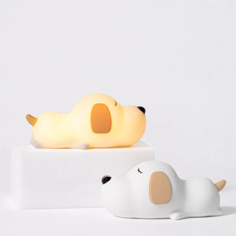 Small two-tone cartoon dog shaped silicone night lamp with USB charging port.