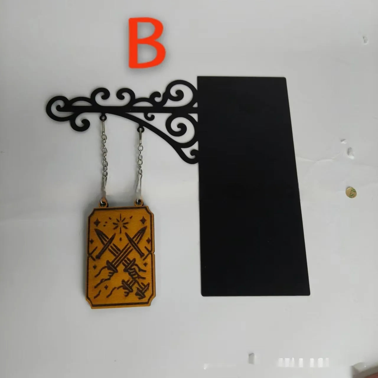 Decorative book nook divider shaped like a medieval tavern sign for shelf organisation