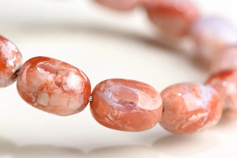 Original design agate bracelet with cherry blossom colour barrel beads and Ruyi charm.