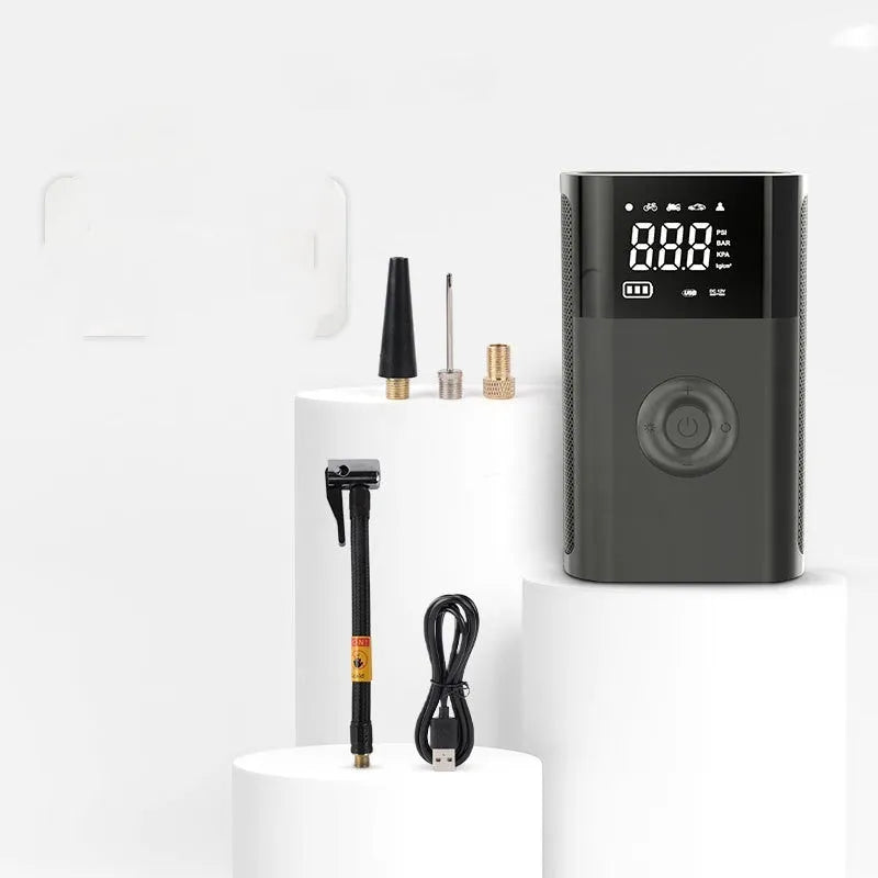 Wireless handheld digital tyre inflator with LCD screen, pressure gauge, and assorted nozzle attachments on a black background.