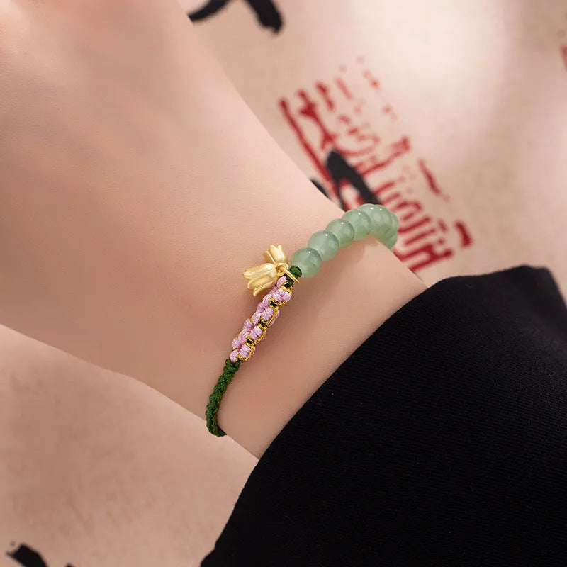 Hand woven red rope bracelet with floral design elements in Lily Carrying Strap colour
