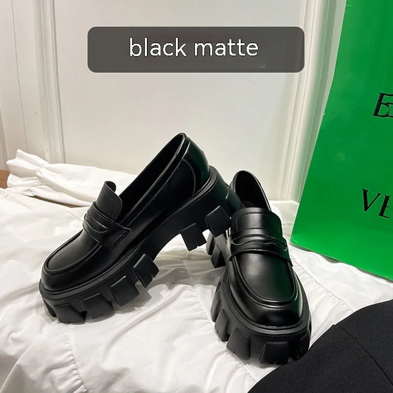 British style wide-fit loafers in patent leather with a muffin base heel and rubber sole.