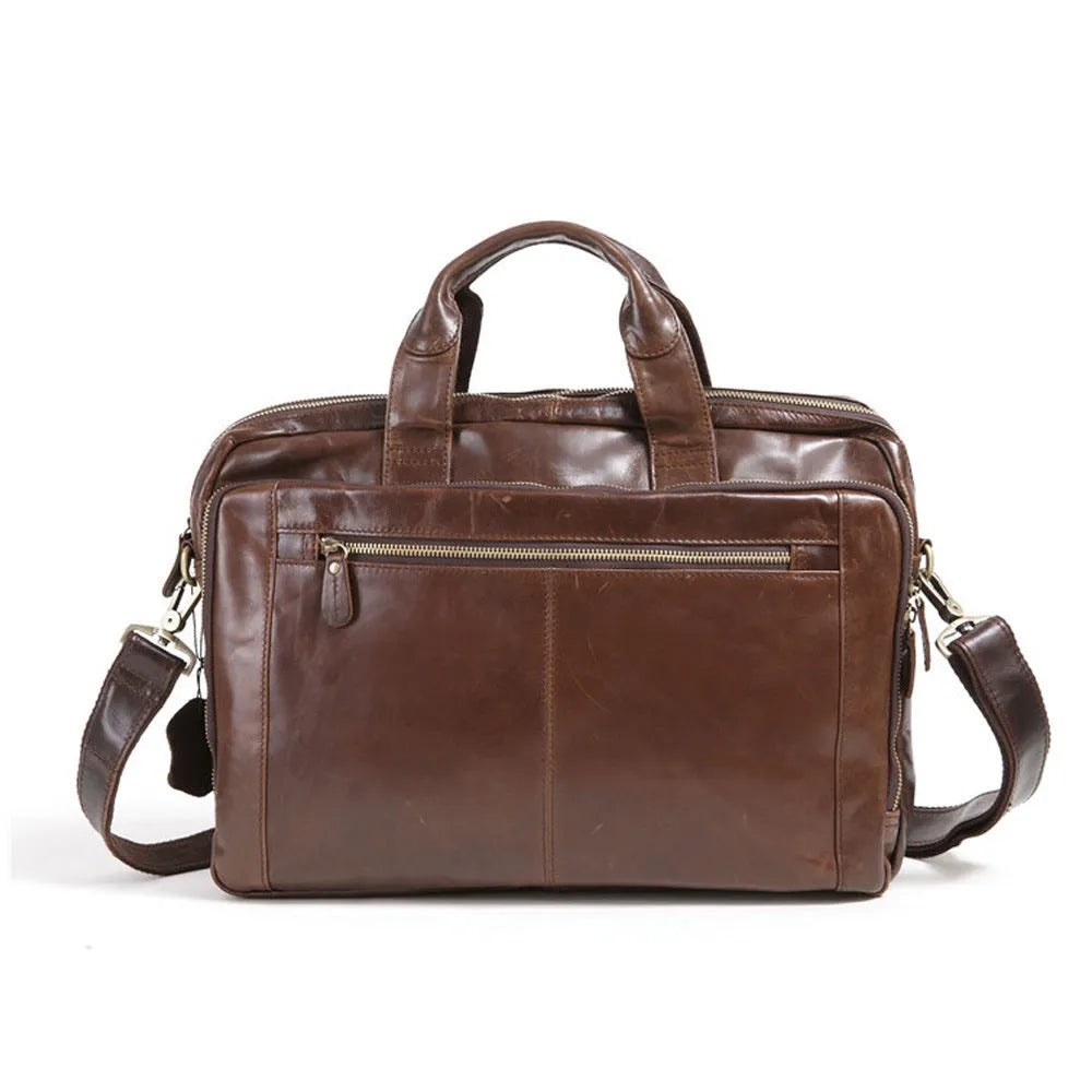 Brown cowhide leather business briefcase open showing interior polyester cotton lining and 18-inch laptop storage