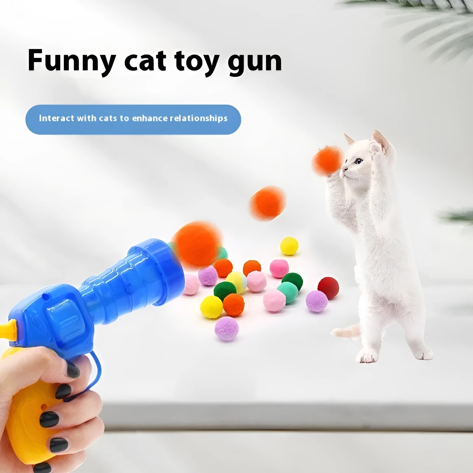 Pet toy launch gun with a selection of soft red plush balls for interactive dog and cat fetch games.