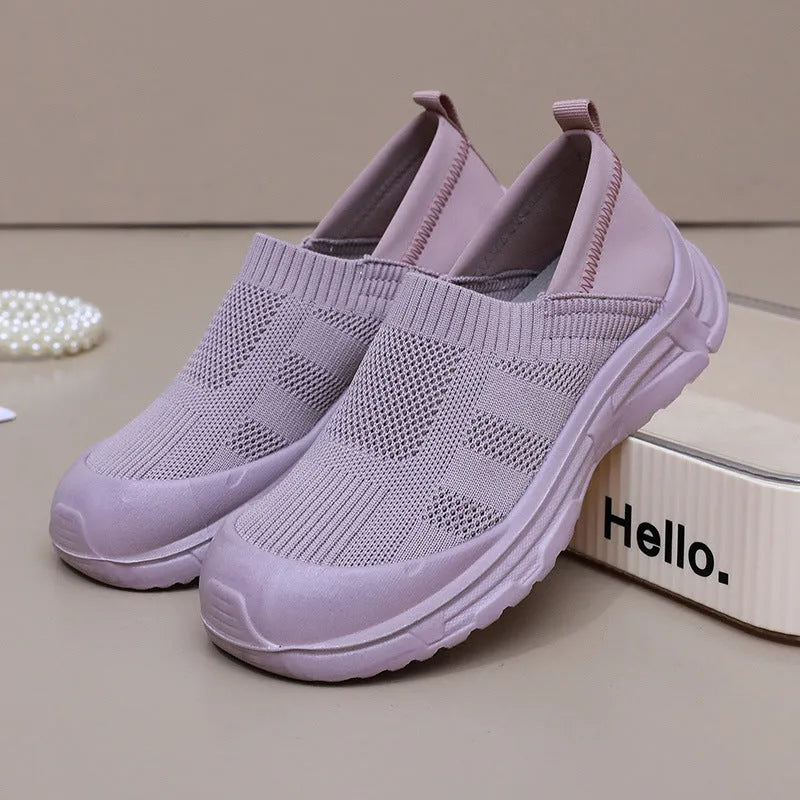 Women's black slip-on casual shoes with round toe and flat PVC sole.