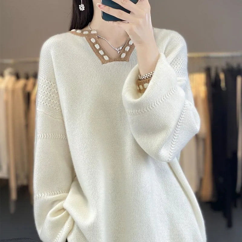 Women's camel V-neck long sleeve viscose sweater laid flat.