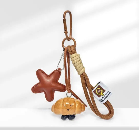 Handmade soda bread handbag pendant with food-themed designs and brown carrying strap