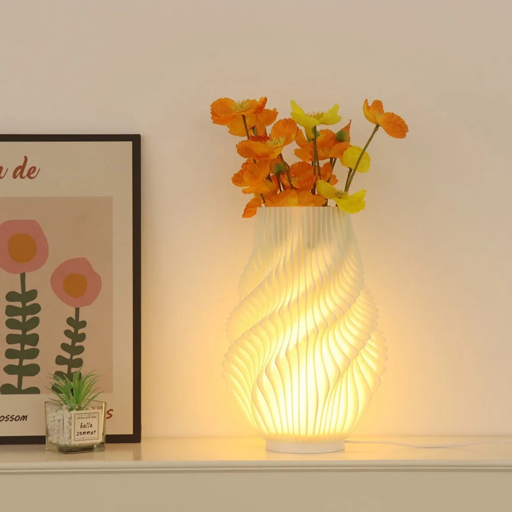 3D printed cylindrical vase night lamp with glass shade in wood colour finish on a bedside table