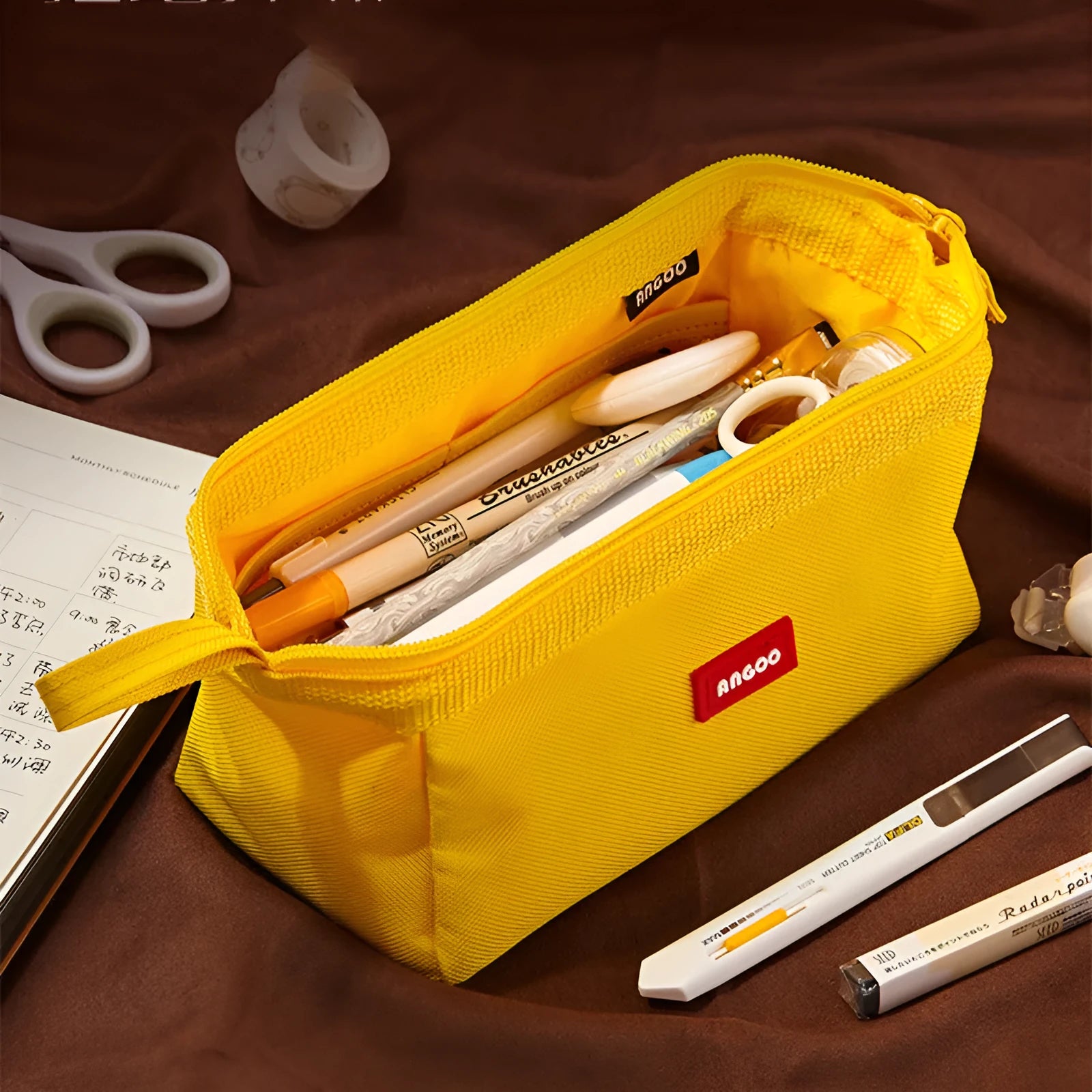 Large canvas pencil case with double zipper open, showing spacious interior for pens and pencils, in yellow colour.