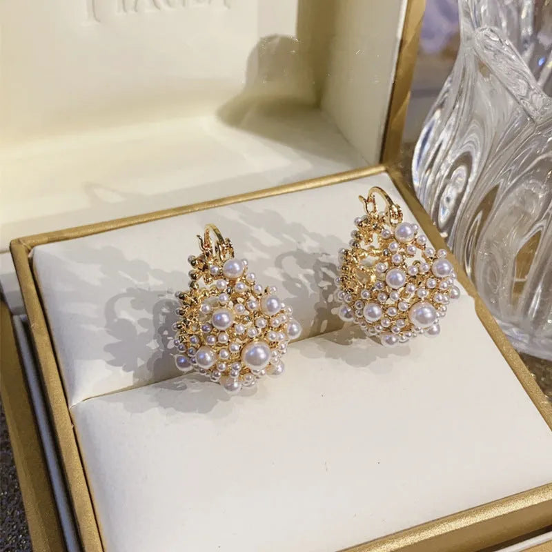 Gold floral basket earrings with pearl inlay detail on rice-shaped beads