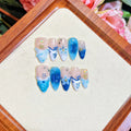 Blue hand-painted carved summer ice transparent plastic fake nails set showing carved detailing and four size options