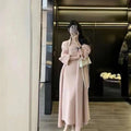 Women's grey knitted cardigan and long skirt suit set with flocking texture detail.