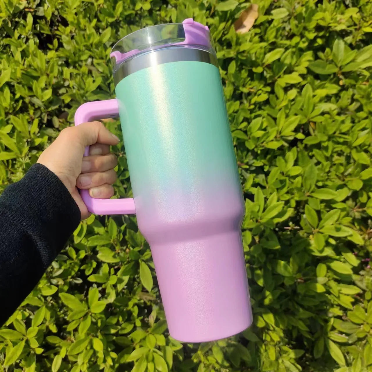 Large stainless steel vacuum cup in a rainbow colour gradient showing its size and lid.