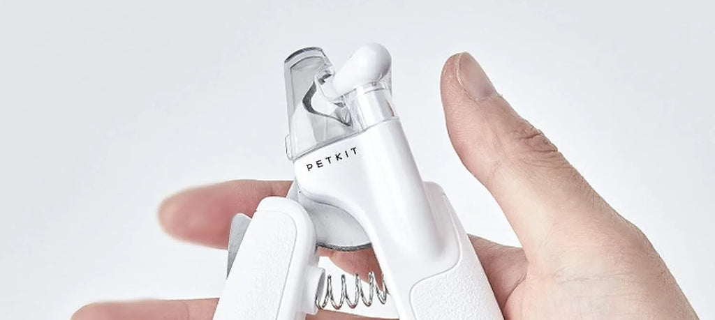 White pet nail clippers with LED light on the handle and a clear anti-splash guard covering the blades.