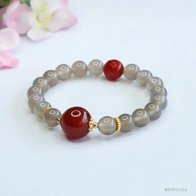Smoky purple chalcedony red agate bracelet with 8mm geometric beads on a wrist.