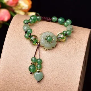 Women's hand-woven bracelet with Chinese auspicious patterns showing flower elements and mixed material texture