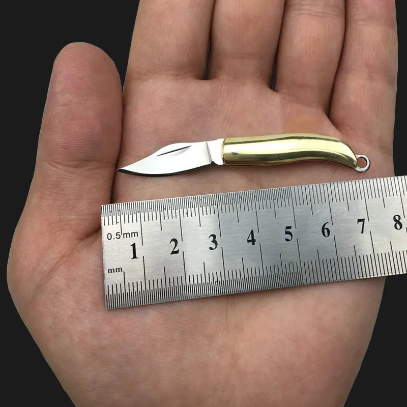 Brass mini folding knife keychain pendant with 3cm blade and 42mm shank on a key ring