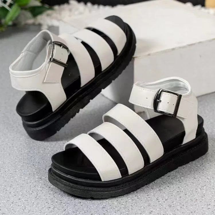 Black beach sandals with thick rubber soles and silver buckle strap fastening