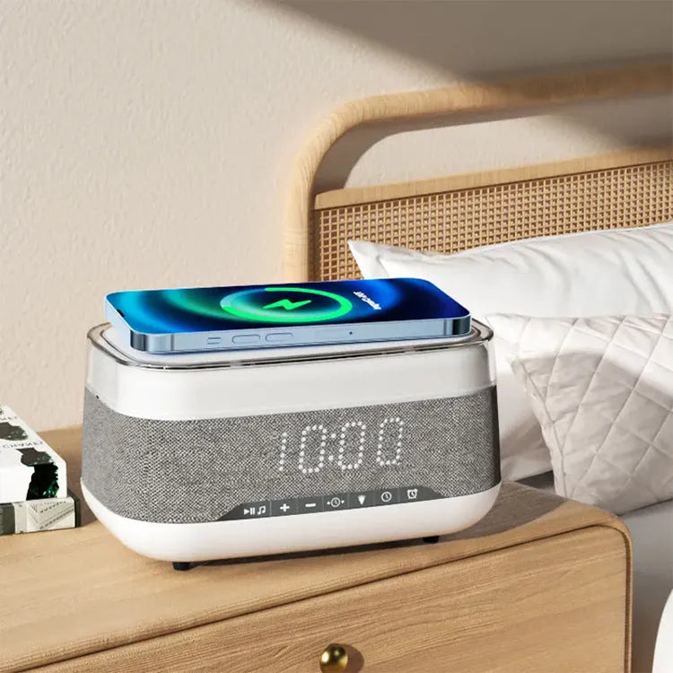 White alarm clock with wireless charging surface and Bluetooth speaker functionality for bedside use